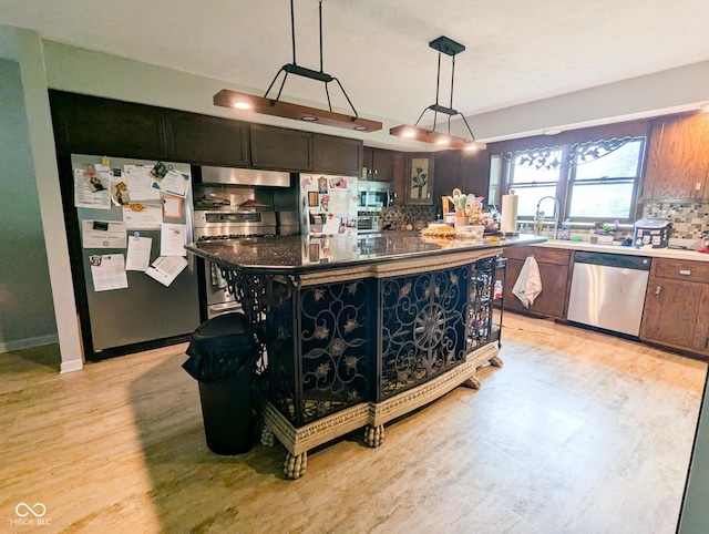 6336 N Carroll Rd, Indianapolis, IN 46235 - kitchen with stainless steel appliances, tasteful backsplash, a center island, a sink, and decorative light fixtures