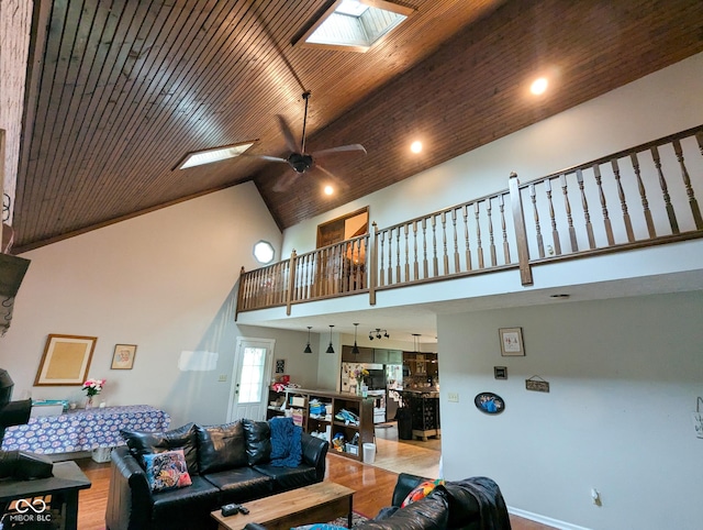 6336 N Carroll Rd, Indianapolis, IN 46235 - living room with high vaulted ceiling, a skylight, wood finished floors, a ceiling fan, and recessed lighting
