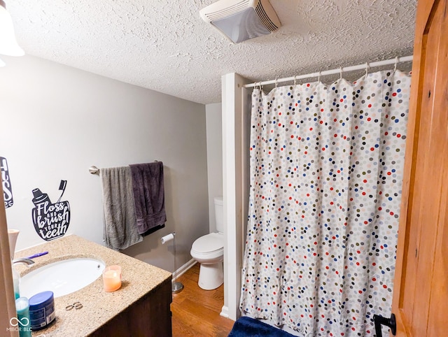 6336 N Carroll Rd, Indianapolis, IN 46235 - bathroom with toilet, a textured ceiling, wood finished floors, vanity, and a shower with curtain