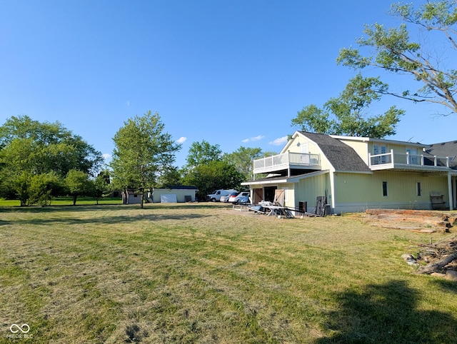 6336 N Carroll Rd, Indianapolis, IN 46235 - view of grassy yard featuring a balcony