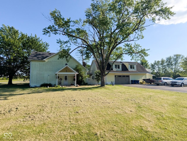 6336 N Carroll Rd, Indianapolis, IN 46235 - view of front of property featuring a garage, asphalt driveway, and a front yard