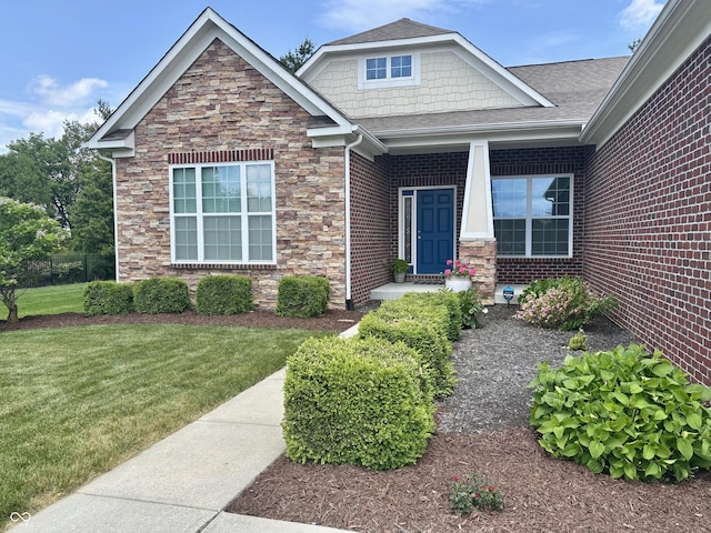 11700 Harvest Moon Dr, Noblesville, IN 46060 - view of front of property with stone siding, a front yard, and a shingled roof