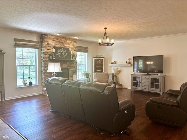 11700 Harvest Moon Dr, Noblesville, IN 46060 - living area with hardwood / wood-style flooring, a textured ceiling, ornamental molding, a chandelier, and a stone fireplace