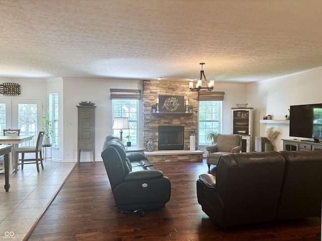 11700 Harvest Moon Dr, Noblesville, IN 46060 - living area featuring healthy amount of natural light, wood-type flooring, a textured ceiling, a chandelier, and crown molding