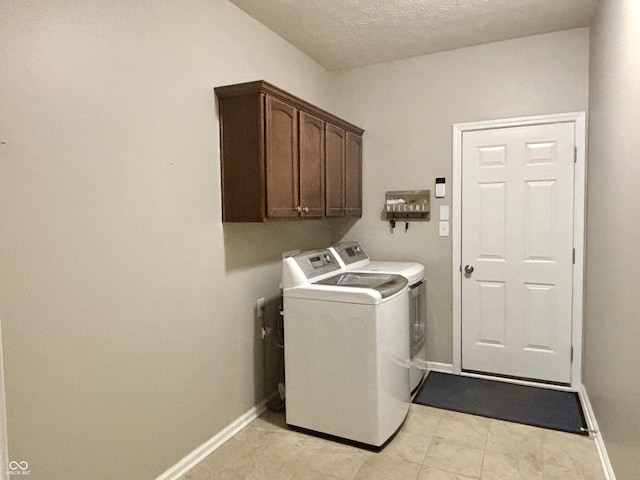 11700 Harvest Moon Dr, Noblesville, IN 46060 - washroom featuring washing machine and dryer, cabinet space, and a textured ceiling