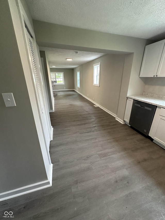 906 N Wabash Ave, Hartford City, IN 47348 - kitchen with stainless steel dishwasher, dark wood-style flooring, a textured ceiling, baseboards, and white cabinets