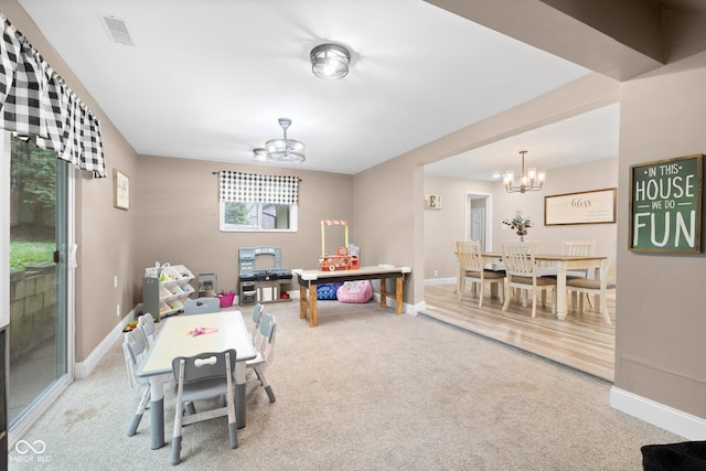 213 Terre Vista Dr, Terre Haute, IN 47803 - game room with a chandelier, carpet flooring, and baseboards