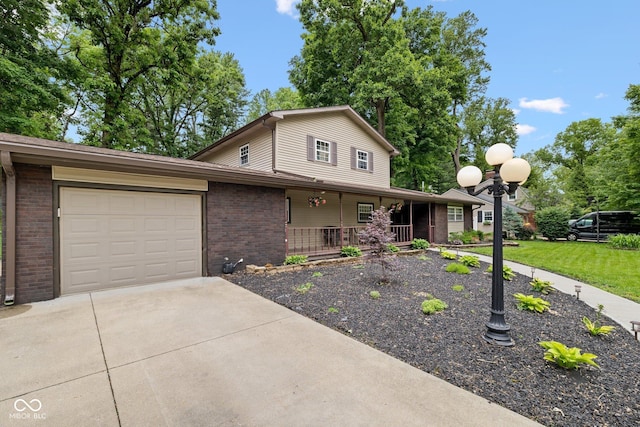 213 Terre Vista Dr, Terre Haute, IN 47803 - view of front of property featuring brick siding, a porch, an attached garage, concrete driveway, and a front yard