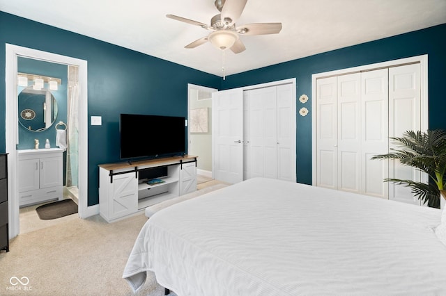 213 Terre Vista Dr, Terre Haute, IN 47803 - bedroom with multiple closets, baseboards, light colored carpet, ceiling fan, and ensuite bathroom