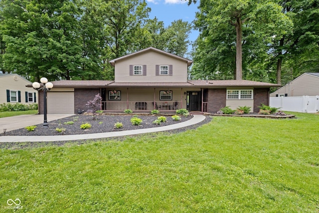 213 Terre Vista Dr, Terre Haute, IN 47803 - view of front of house with a garage, covered porch, and driveway