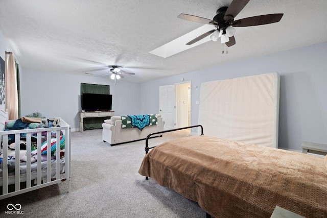 213 Terre Vista Dr, Terre Haute, IN 47803 - carpeted bedroom with a skylight, a textured ceiling, ceiling fan, and baseboards