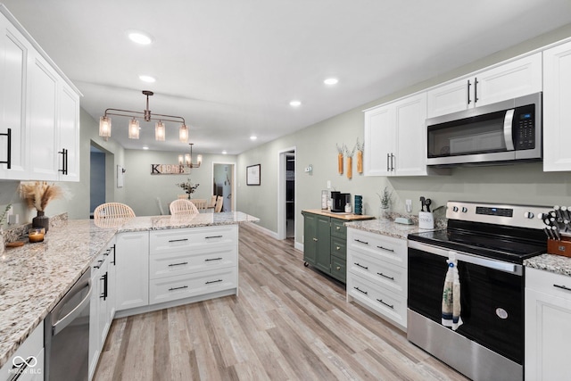 213 Terre Vista Dr, Terre Haute, IN 47803 - kitchen featuring stainless steel appliances, recessed lighting, a peninsula, white cabinetry, and light wood-style flooring