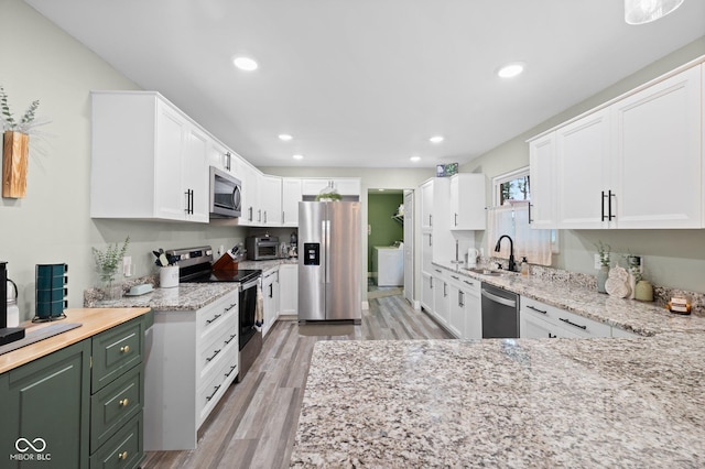 213 Terre Vista Dr, Terre Haute, IN 47803 - kitchen featuring stainless steel appliances, a sink, light stone countertops, white cabinetry, and recessed lighting