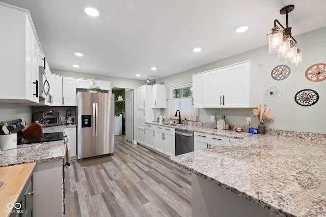 213 Terre Vista Dr, Terre Haute, IN 47803 - kitchen featuring stainless steel appliances, a sink, light stone countertops, light wood-style flooring, and white cabinets