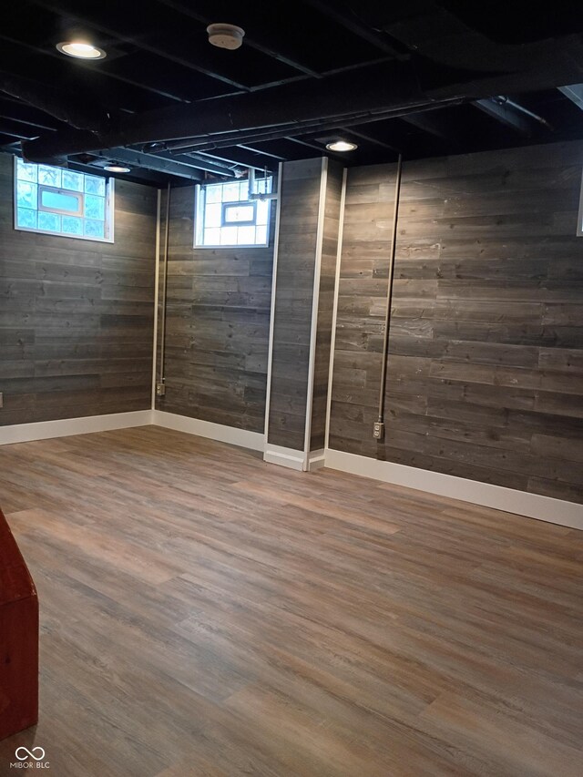 1008 E 61st St, Indianapolis, IN 46220 - basement featuring wood walls, healthy amount of natural light, wood finished floors, and baseboards