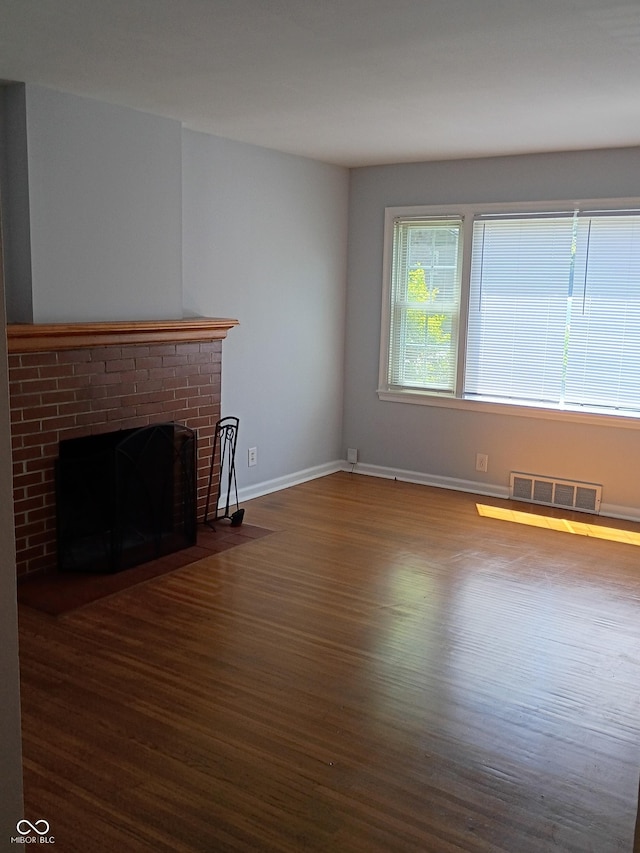 1008 E 61st St, Indianapolis, IN 46220 - unfurnished living room featuring wood finished floors, baseboards, and a fireplace
