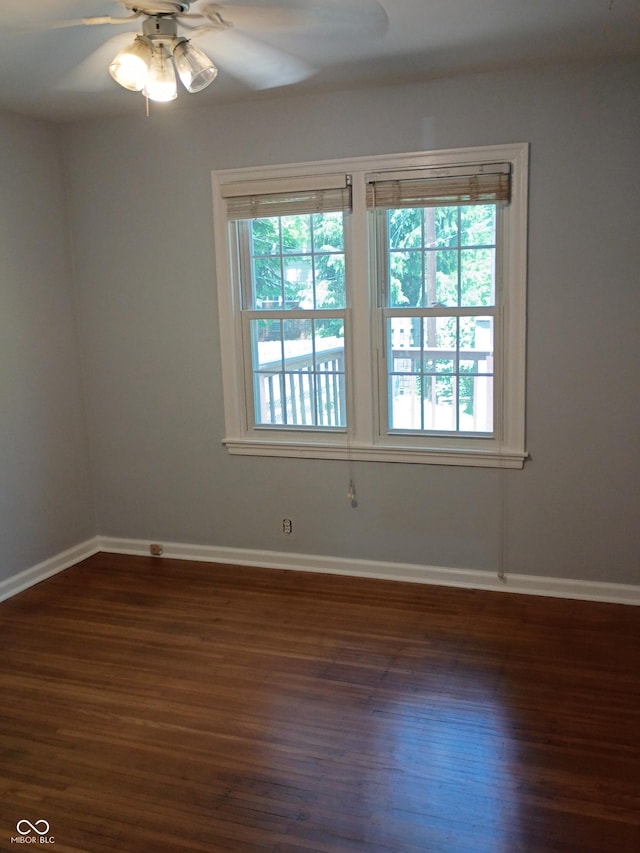1008 E 61st St, Indianapolis, IN 46220 - empty room with dark wood-style flooring, plenty of natural light, and a ceiling fan