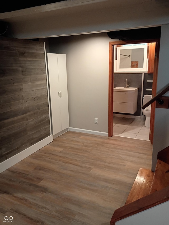 1008 E 61st St, Indianapolis, IN 46220 - finished below grade area with baseboards, wood finished floors, and a sink