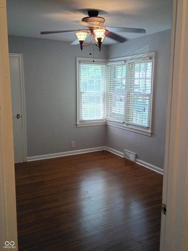 1008 E 61st St, Indianapolis, IN 46220 - unfurnished room with ceiling fan, dark wood-style flooring, and baseboards