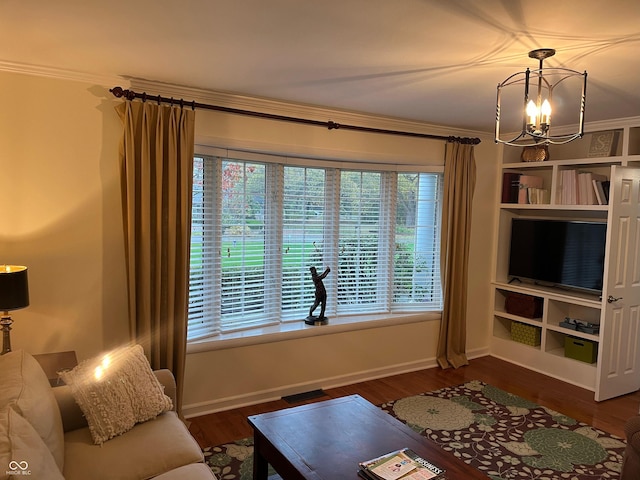 9510 Copley Dr, Indianapolis, IN 46260 - living room with crown molding, wood finished floors, baseboards, and a chandelier