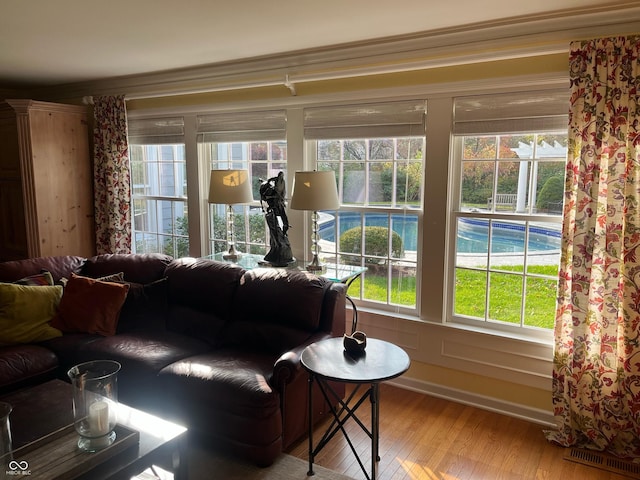 9510 Copley Dr, Indianapolis, IN 46260 - living area with wood finished floors, healthy amount of natural light, and ornamental molding