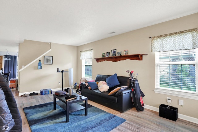 15264 Ten Point Dr, Noblesville, IN 46060 - living area featuring light wood finished floors, baseboards, and a textured ceiling