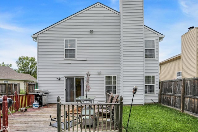 15264 Ten Point Dr, Noblesville, IN 46060 - back of property with a deck, a chimney, and outdoor dining area
