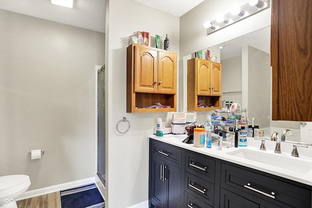 15264 Ten Point Dr, Noblesville, IN 46060 - bathroom with a shower stall, vanity, toilet, baseboards, and wood finished floors