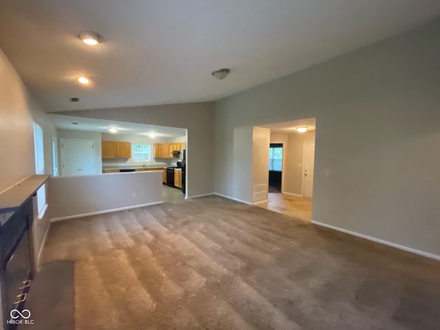 356 Seabreeze Cir, Avon, IN 46123 - unfurnished living room with vaulted ceiling, light colored carpet, and baseboards