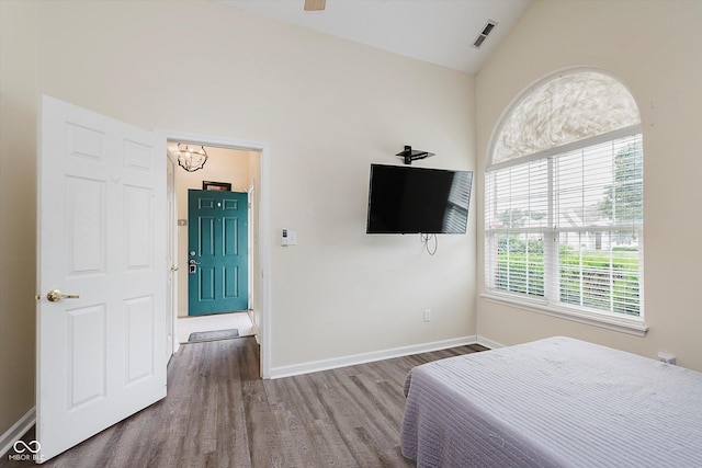 5939 Oberlies Way, Plainfield, IN 46168 - bedroom with wood finished floors, multiple windows, lofted ceiling, a chandelier, and baseboards