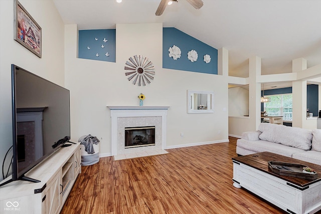 5939 Oberlies Way, Plainfield, IN 46168 - living area with a tile fireplace, ceiling fan, wood finished floors, high vaulted ceiling, and baseboards