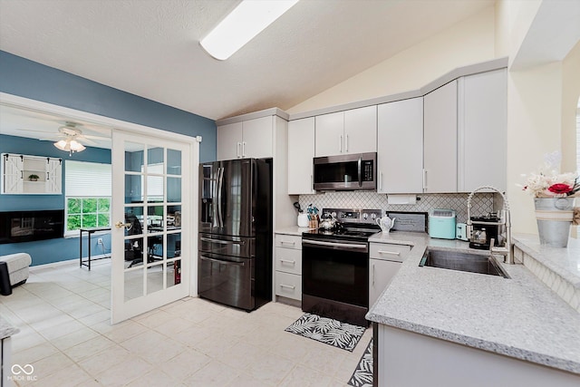 5939 Oberlies Way, Plainfield, IN 46168 - kitchen with black fridge with ice dispenser, stainless steel microwave, electric stove, tasteful backsplash, and lofted ceiling