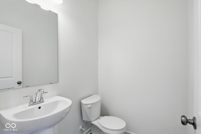 3931 Wren Dr, Brownsburg, IN 46112 - bathroom featuring a sink, toilet, and baseboards