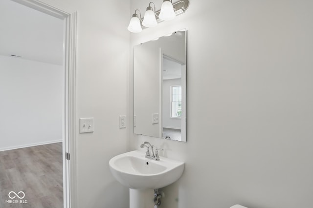 3931 Wren Dr, Brownsburg, IN 46112 - half bathroom with a sink and wood finished floors