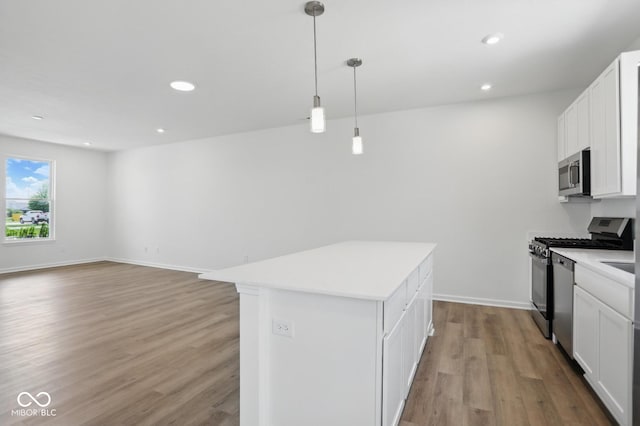 3931 Wren Dr, Brownsburg, IN 46112 - kitchen featuring appliances with stainless steel finishes, light wood finished floors, light countertops, white cabinetry, and recessed lighting