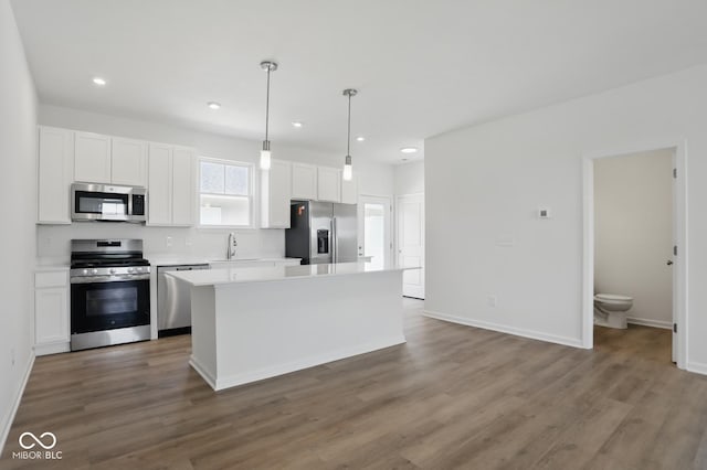3931 Wren Dr, Brownsburg, IN 46112 - kitchen with appliances with stainless steel finishes, white cabinets, wood finished floors, light countertops, and recessed lighting