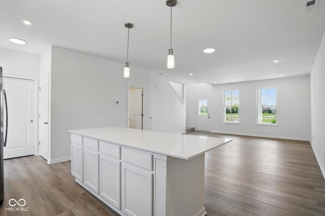 3931 Wren Dr, Brownsburg, IN 46112 - kitchen featuring wood finished floors, a center island, hanging light fixtures, white cabinets, and recessed lighting