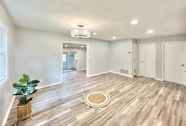 3594 Roland Dr, Kingman, IN 47952 - empty room with light wood finished floors, recessed lighting, baseboards, and a textured ceiling