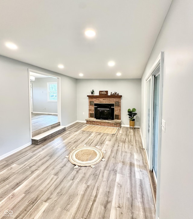 3594 Roland Dr, Kingman, IN 47952 - unfurnished living room with wood finished floors, baseboards, recessed lighting, and a fireplace