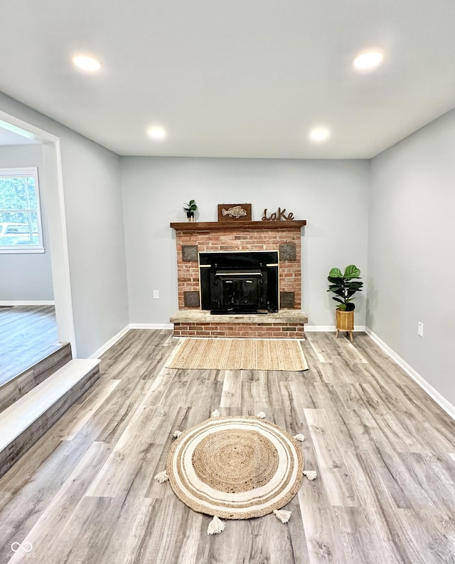 3594 Roland Dr, Kingman, IN 47952 - living room with a brick fireplace, wood finished floors, recessed lighting, and baseboards