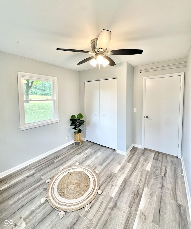 3594 Roland Dr, Kingman, IN 47952 - unfurnished bedroom with wood finished floors, a closet, baseboards, and ceiling fan