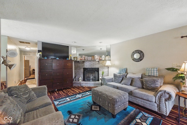 9130 E 18th St, Indianapolis, IN 46229 - living area featuring wood finished floors, a textured ceiling, and a fireplace