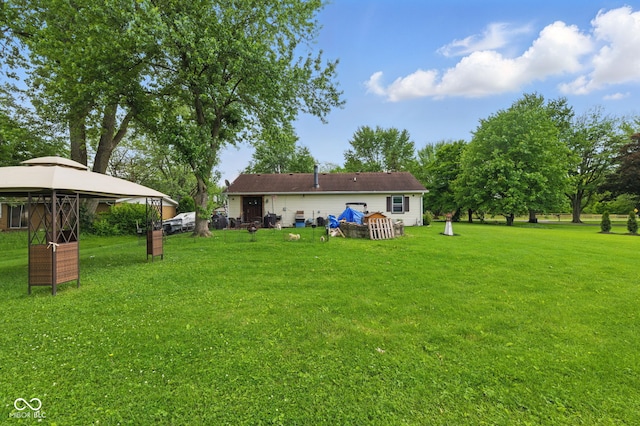 9130 E 18th St, Indianapolis, IN 46229 - back of property featuring a gazebo and a yard