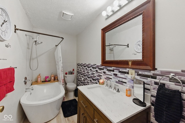 9130 E 18th St, Indianapolis, IN 46229 - full bathroom featuring vanity, shower / bath combination with curtain, toilet, a textured ceiling, and wainscoting