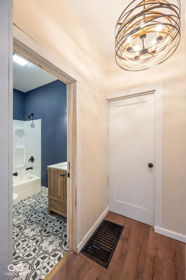 214 S Mcilroy Ave, West Terre Haute, IN 47885 - entrance foyer featuring wood finished floors, a chandelier, and baseboards