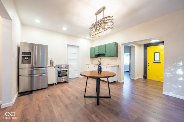 214 S Mcilroy Ave, West Terre Haute, IN 47885 - kitchen featuring stainless steel fridge, wood finished floors, light countertops, baseboards, and recessed lighting