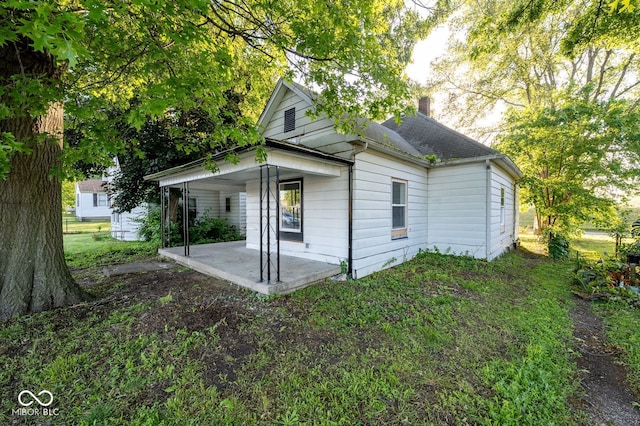 214 S Mcilroy Ave, West Terre Haute, IN 47885 - view of property exterior with a patio and a chimney