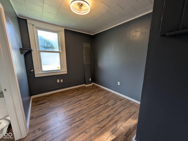 9712 N Price St, Knightsville, IN 47857 - empty room with wood finished floors, ornamental molding, electric panel, and baseboards