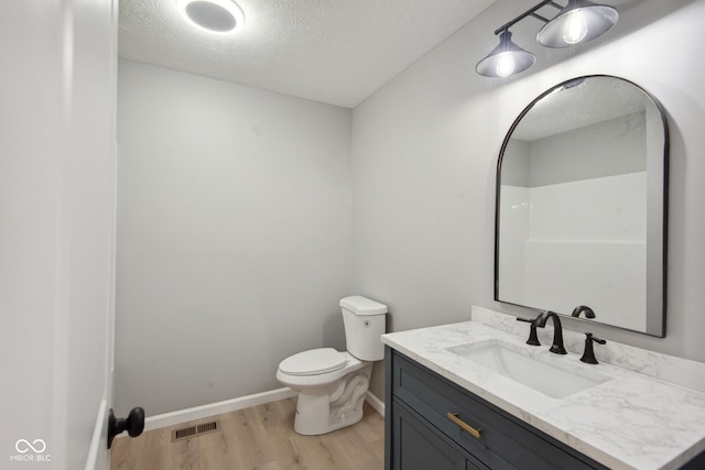 302 Highlawn Ave, Seymour, IN 47274 - full bathroom with wood finished floors, toilet, vanity, a textured ceiling, and baseboards