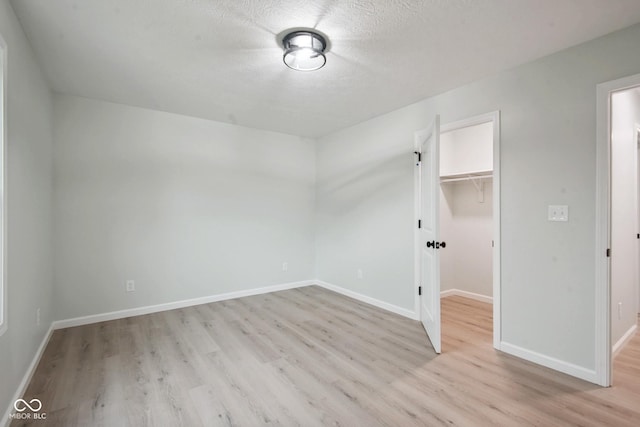 302 Highlawn Ave, Seymour, IN 47274 - unfurnished room with light wood-style floors, baseboards, and a textured ceiling